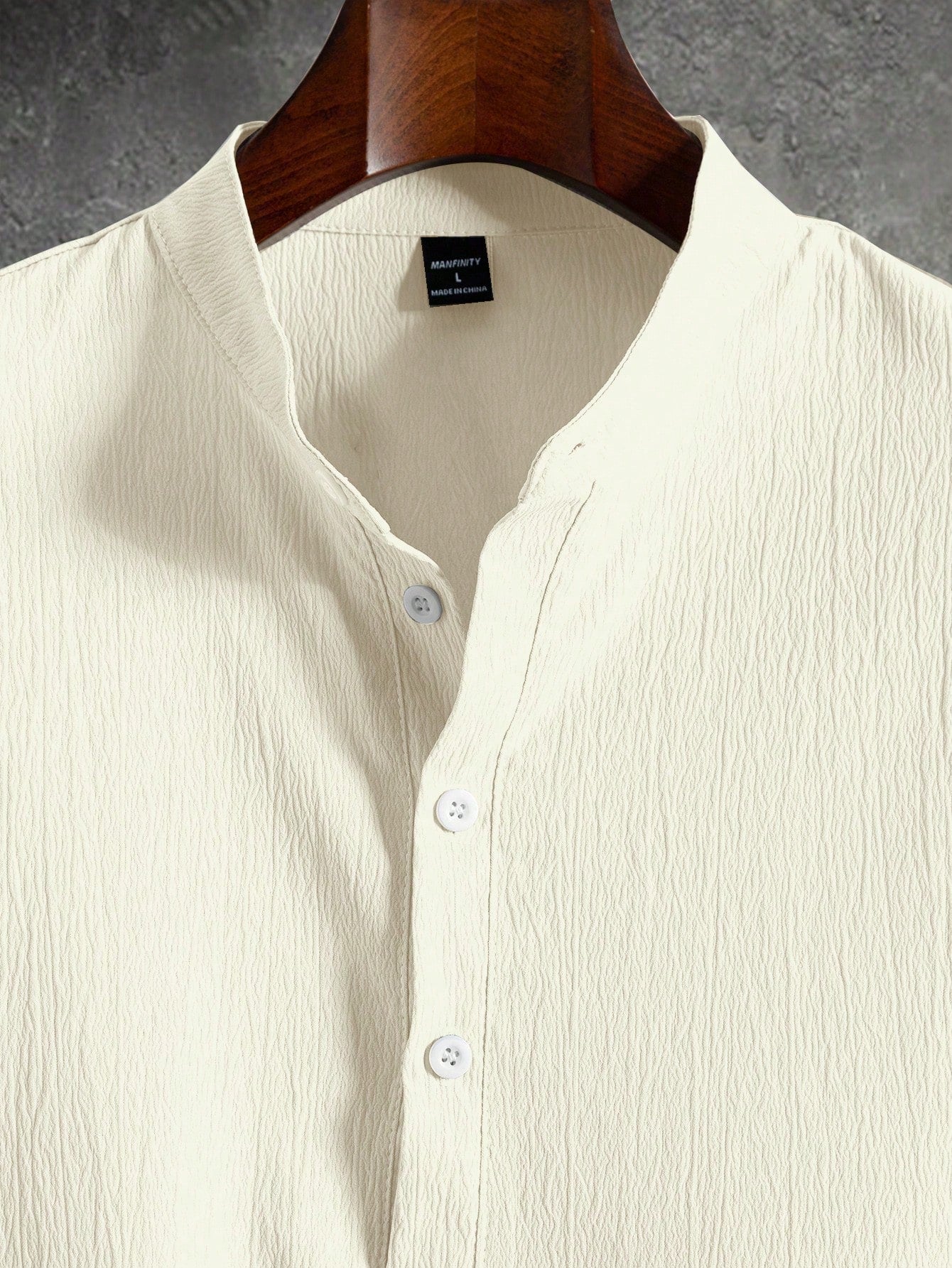 Men’s suit (shirt and trousers) with a relaxed fit and simple design featuring half buttons, suitable for summer.