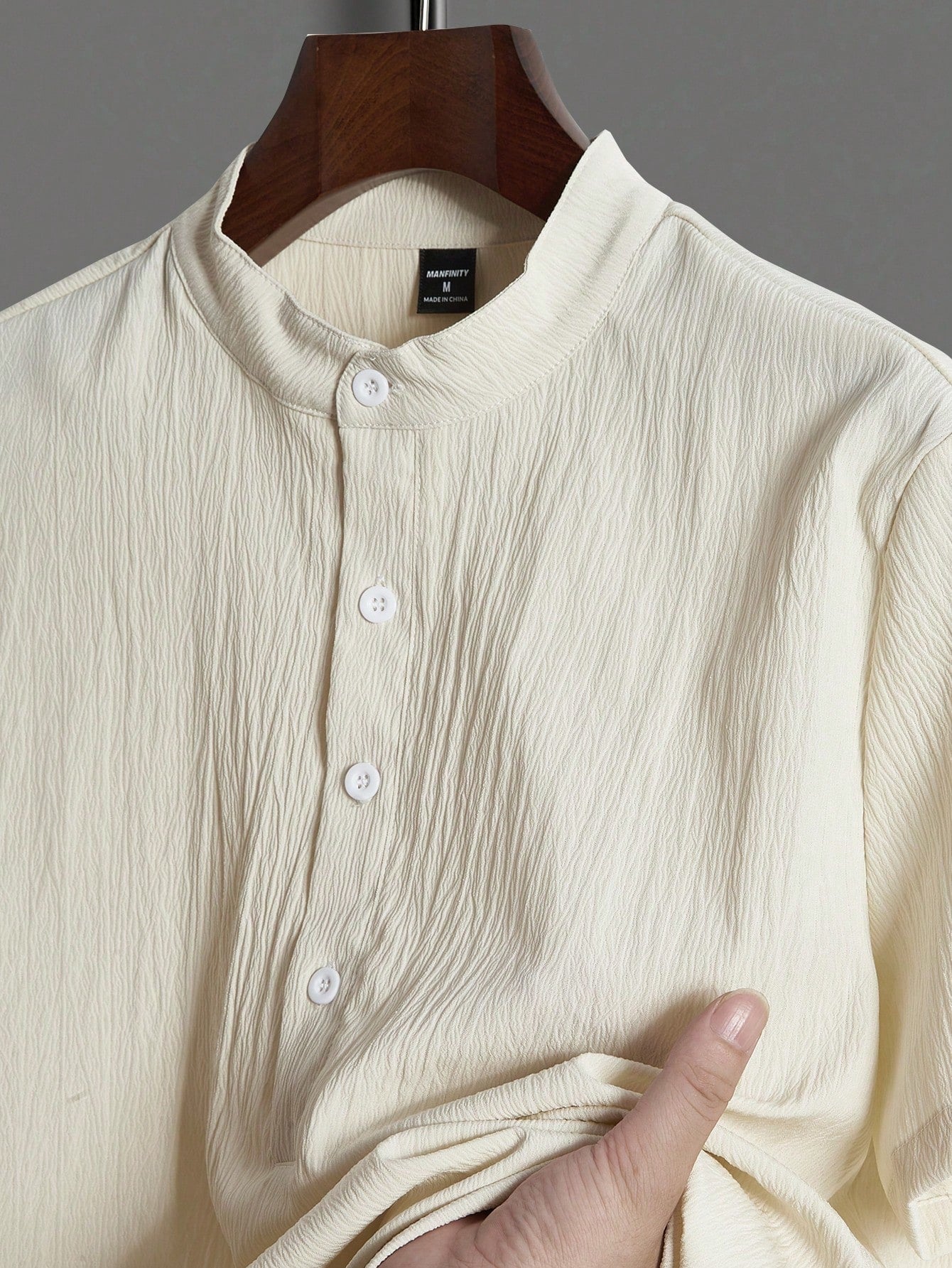 Men’s suit (shirt and trousers) with a relaxed fit and simple design featuring half buttons, suitable for summer.